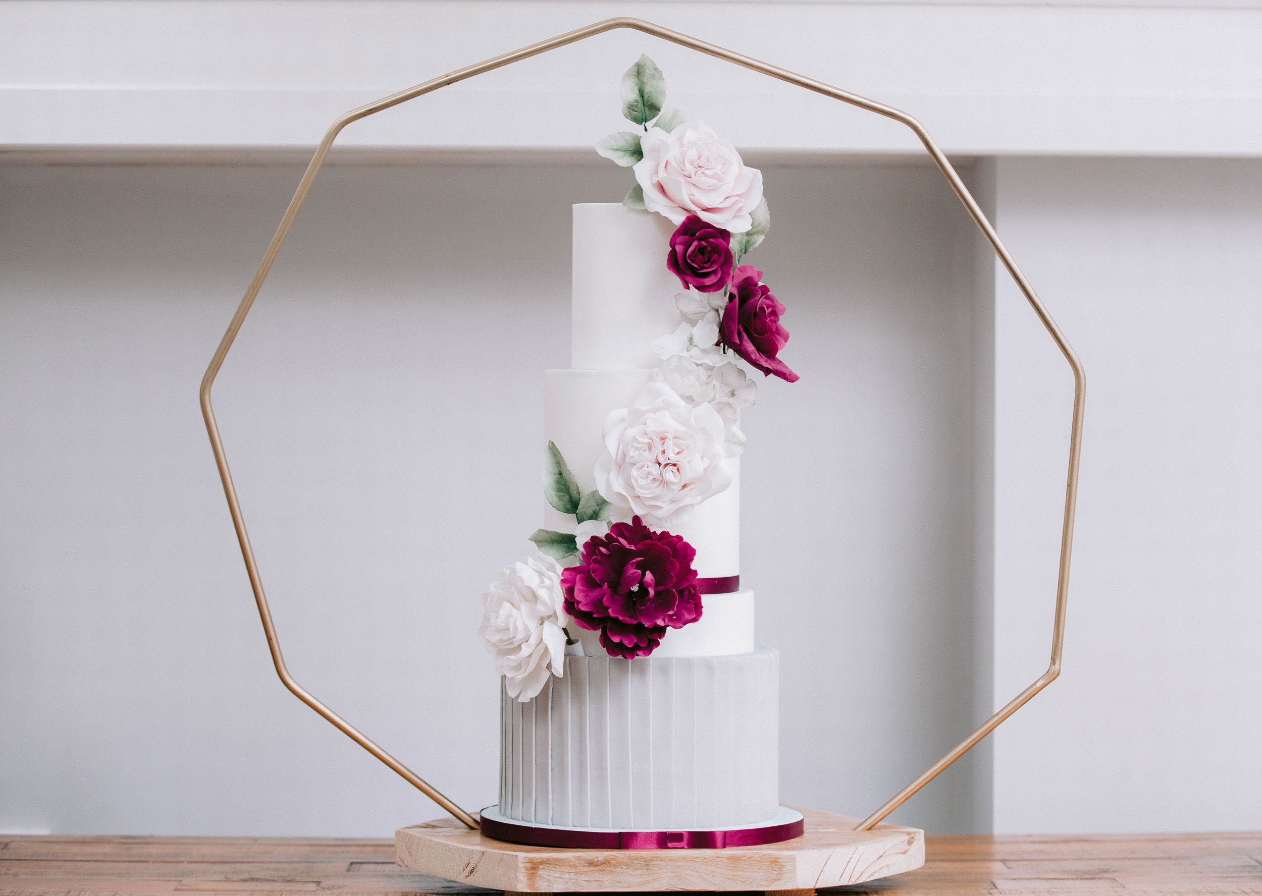 Contemporary 4 tier white wedding cake with sugar flowers and vertical pleats | Louise Hayes Cake Design, Luxury wedding cakes in the Home Counties and London | Meghan Claire Photography