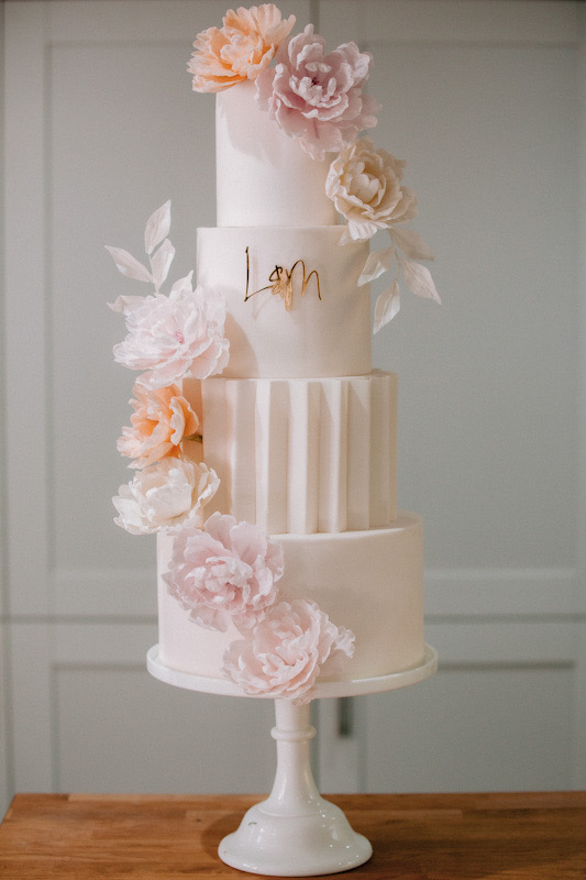 4 tier modern white wedding cake with origami panelling and blush sugar flowers | Louise Hayes Cake Design | Photo by Meghan Claire Photography