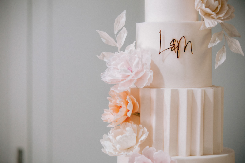 4 tier modern white wedding cake with origami panelling and blush sugar flowers | Louise Hayes Cake Design | Photo by Meghan Claire Photography