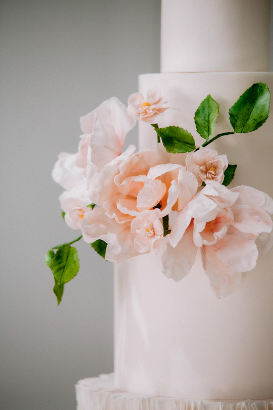 4 tier modern white wedding cake with ruffles and sugar flowers | Louise Hayes Cake Design | Photo by Meghan Claire Photography