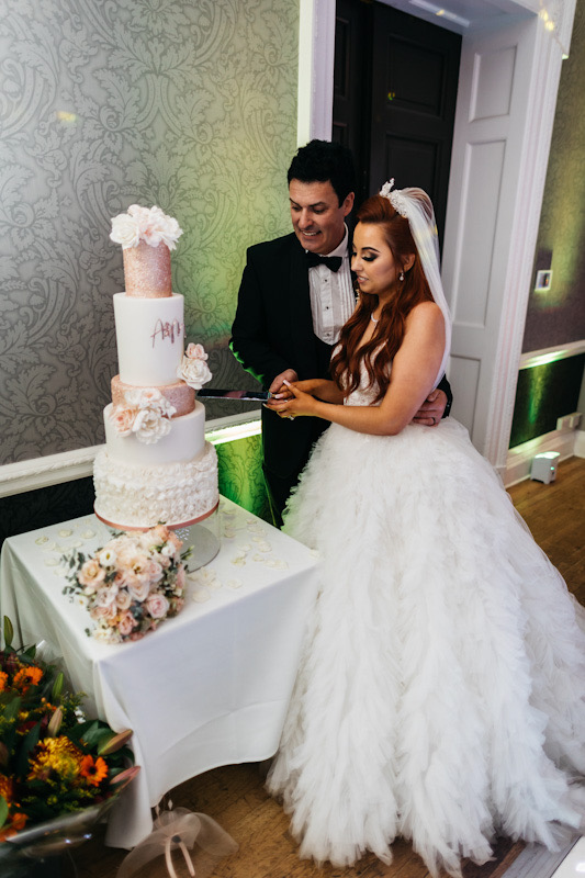 Show-stopper 5 tier white and rose gold blush wedding cake with ruffles, edible glitter and sugar flowers | Berkshire Mansion House wedding, Easthampstead Park | Chris Kemp Photography | Louise Hayes Cake Design