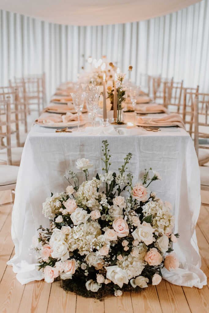 Spring inspired wedding tablescape with blush napkins, elegant stationery, floral arrangements, candles and blush draping fabric sails | Louise Hayes Cake Design | Melissa Megan Photography | Cowdray Wedding