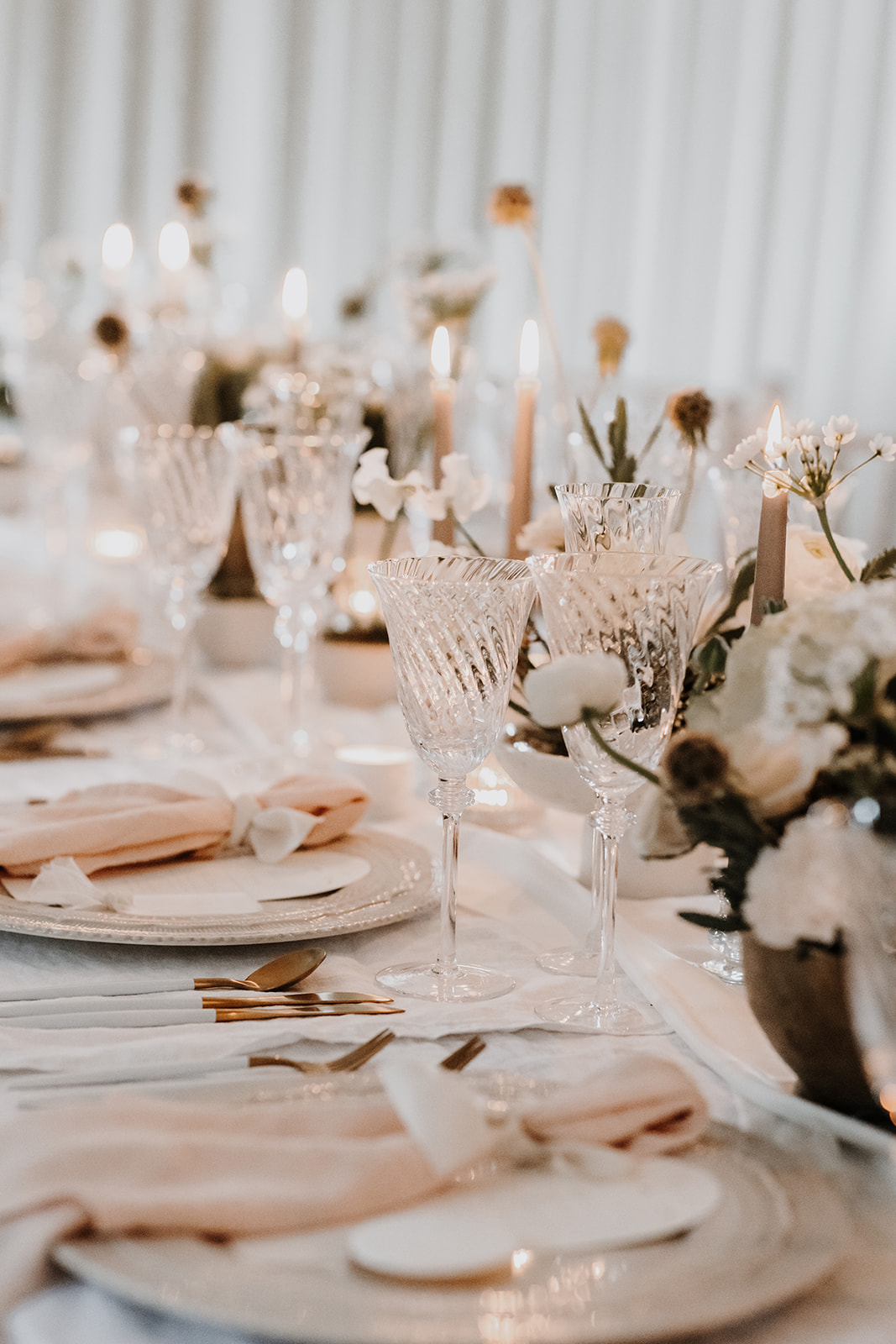 Spring inspired wedding tablescape with blush napkins, elegant stationery, floral arrangements, candles, sugar biscuit favours and blush draping fabric sails | Louise Hayes Cake Design | Melissa Megan Photography | Cowdray Wedding