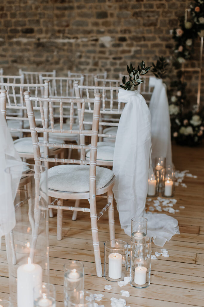 Wedding ceremony room with candles, petals and chairs draped with fabric | Louise Hayes Cake Design | Melissa Megan Photography | Cowdray Wedding