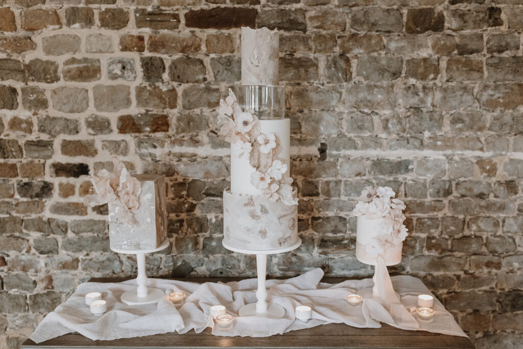 Trio of nude, blush contemporary wedding cakes with wafer paper sails and sugar flowers | Louise Hayes Cake Design | Melissa Megan Photography | Cowdray Wedding