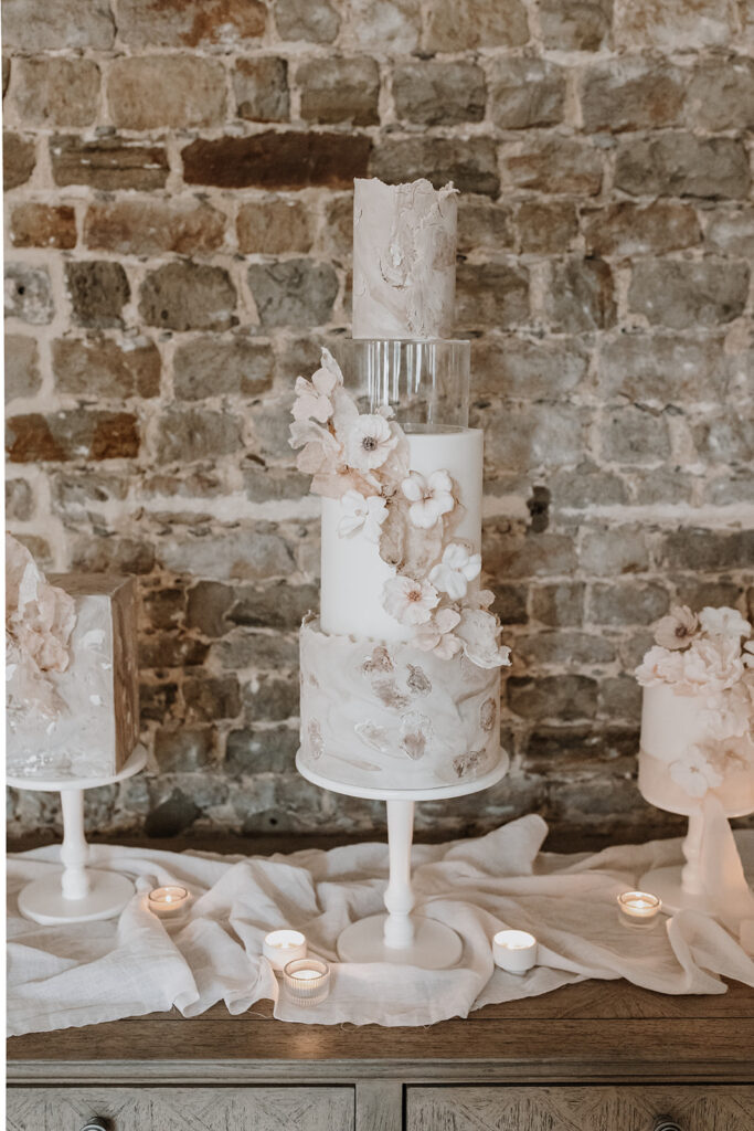 Trio of nude, blush contemporary wedding cakes with wafer paper sails and sugar flowers | Louise Hayes Cake Design | Melissa Megan Photography | Cowdray Wedding